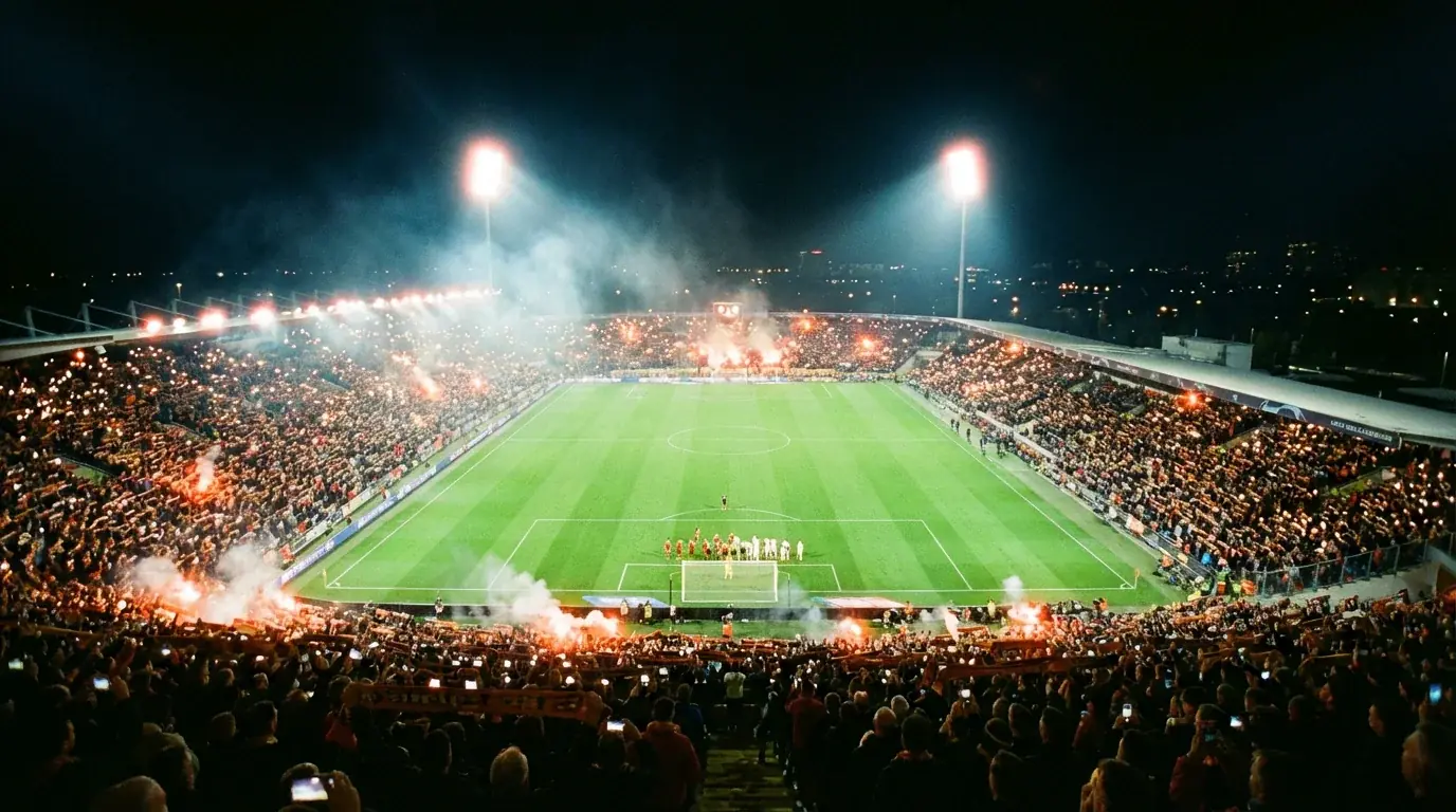 Éjszakai futballmérkőzés egy kivilágított stadionban, szurkolókkal teli lelátók és reflektorok fénye